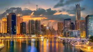 Dubai Marina skyline at dusk with illuminated residential towers