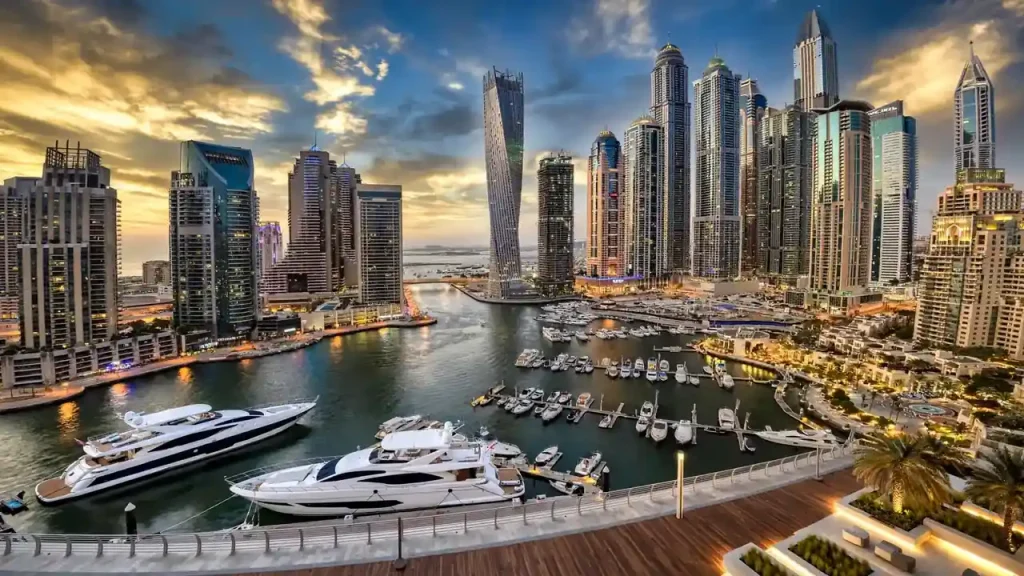 How to Maximize Airbnb Income & Profit in Dubai Dubai Marina skyline at dusk behind luxury short-term rental towers